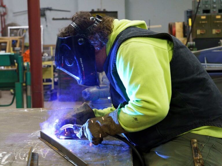 A student welding in a CTE class